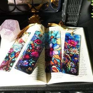 Translucent acrylic bookmarks with golden tassels, colorful floral stained glass design.