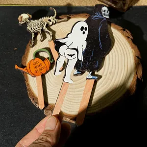 Funny wooden plant stake detail shot showing humorous ghost design for small potted plant decor.