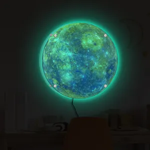 Glowing 3D moon wall light detail showing vibrant green LED backlighting and modern home design.