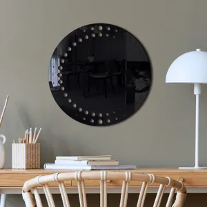 Circular black acrylic wall mirror sticker with decorative dot cutout pattern for modern home decor