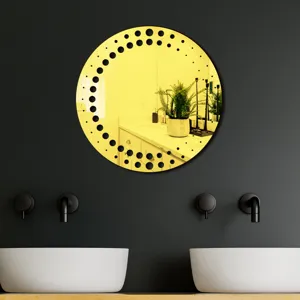 Detail view of a round gold decorative acrylic wall mirror sticker with modern black dot border.