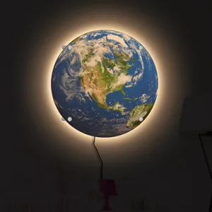 Creative LED earth wall lamp with warm ambient backlight for modern home decor night lighting.