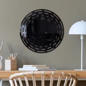 Close-up view of a decorative round cutout wall mirror displayed in a stylish modern study room.