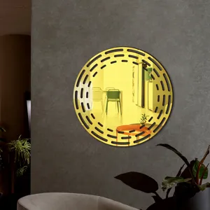 Decorative round acrylic wall mirror with hollow black border detail for modern home interior decor.