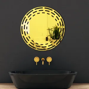 Detail shot of a round acrylic wall decorative mirror in gold with stylish black design.