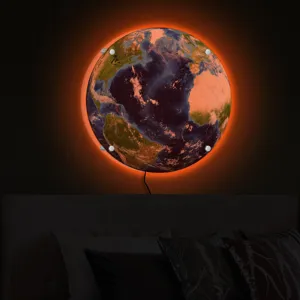 Glowing earth wall lamp detail shot showing the textured planet surface and warm ambient backlight.