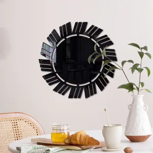 Close-up view of the black acrylic wall mirror detail, mounted on a cozy dining room wall.