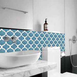 Moroccan tile sticker detail showing blue quatrefoil design applied on modern bathroom wall.