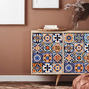 Detailed view of Moroccan tile stickers applied on cabinet, vintage blue and orange patterns.