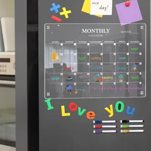 Clear acrylic monthly calendar magnetic fridge dry erase board with markers for daily planning.