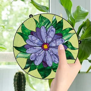 Detailed shot of a vibrant purple flower stained glass hanging decor in a bright home setting.