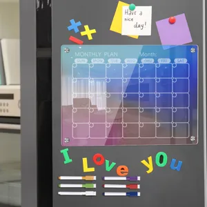 Colorful acrylic magnetic monthly planner board for fridge with dry erase markers and notes.