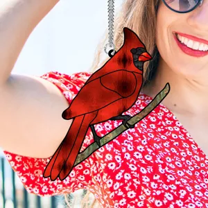 Detailed view of the vibrant red cardinal bird acrylic hanging ornament displayed naturally.