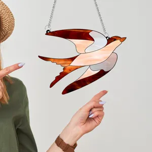 Detailed view of the acrylic bird hanging decoration showing the vibrant stained glass effect.