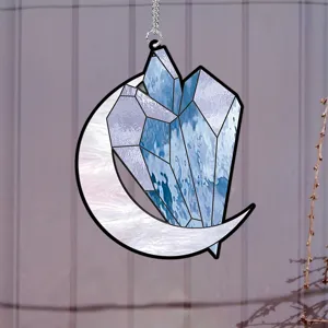 Detailed view of stained glass style moon and blue crystal hanging pendant home decor accent.