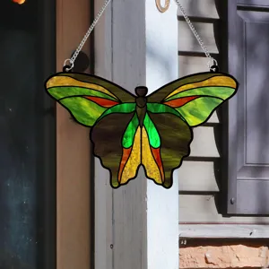 Stained glass butterfly suncatcher detail shot, colorful hanging pendant for home wall and window.