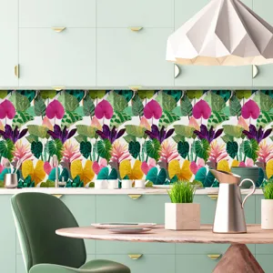 Vista dettagliata dell'adesivo murale con motivo a foglie tropicali nella cucina.