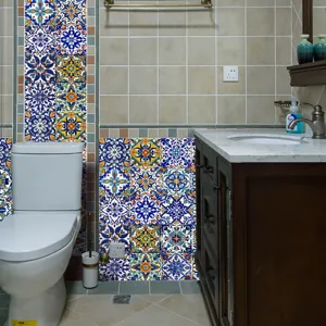 Detailed view of Moroccan style tile stickers applied on bathroom wall, showing rich blue patterns.