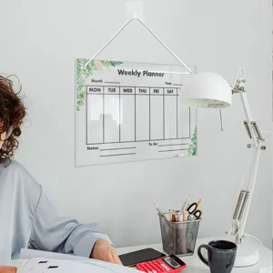Hanging acrylic weekly planner board, erasable memo calendar for office and home decor.