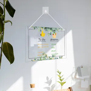 Clear acrylic hanging dry erase memo board with eucalyptus leaves design for home office use.