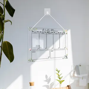 Clear acrylic weekly planner board with hanging rope for wall organization and notes.