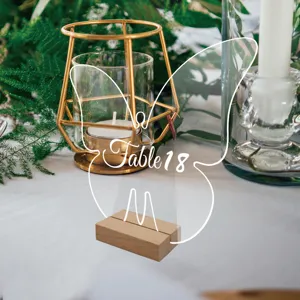 Acrylic butterfly table number sign detail view, elegant wedding desk decor with wood base.