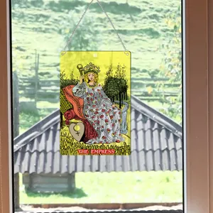 Detail shot of a tarot card window hanging ornament with chain, vintage style wall decor.