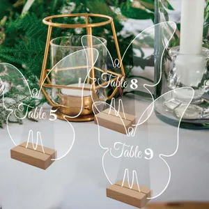 Transparent acrylic butterfly table number sign with wooden base for wedding decor party.