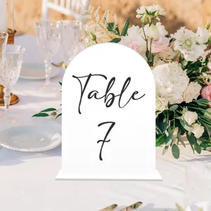 Acrylic arched table number card for wedding reception, elegant tabletop decor detail shot.
