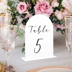White acrylic arch table number sign with base for wedding party decor detail shot.