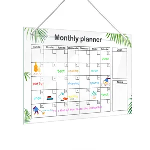 Clear acrylic hanging monthly planner board with palm leaf design for home office wall.