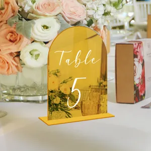 Gold acrylic arch wedding table number sign, elegant tabletop decor for reception.