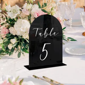 Black acrylic arched table number sign with base for wedding party decoration detail view.