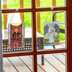 Tarot card window hanging detail showing classic Justice and Temperance designs on clear glass.