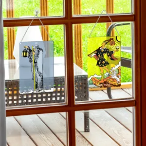 Tarot card window hanging detail showing transparent Hermit and Fool designs with metal chains.