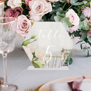 Detalle de número de mesa de boda hexagonal de acrílico transparente con soporte.