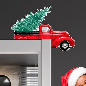 Christmas wooden door corner decoration showing vintage red truck with tree detail view.