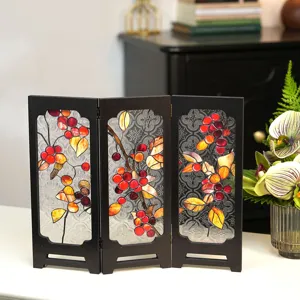 Close-up of the vintage tabletop folding screen with embossed glass and colorful berry patterns.