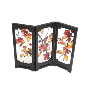 Detailed view of miniature retro table screen with red berries leaf pattern, vintage decor.