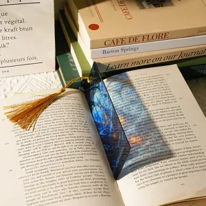 Translucent acrylic dragon bookmark with tassel detail, perfect for readers and book lovers.