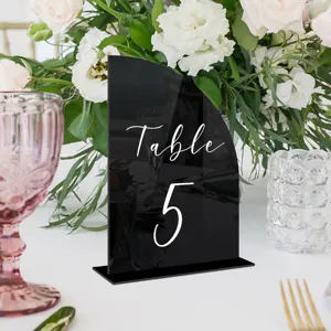 Black acrylic table sign detail, arch design, elegant wedding table number decor setup.