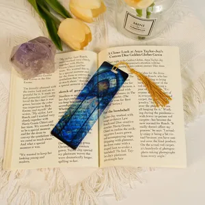 Translucent acrylic bookmark featuring a dragon pattern and elegant gold tassel for reading