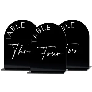 Black arch acrylic wedding table number sign with white printed text and sturdy base.