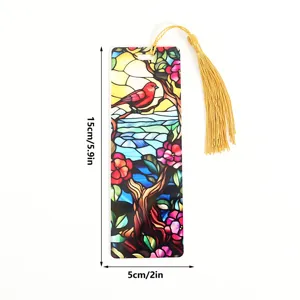 Detailed view of stained glass style bookmark with red bird pattern and gold tassel.
