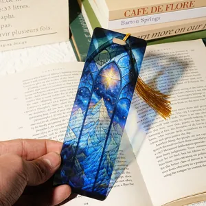 Exquisite translucent acrylic bookmark featuring a starry night and mountain design with a tassel.