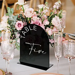 Black acrylic table number sign detail, elegant wedding decor tabletop centerpiece.