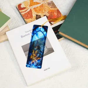 Translucent acrylic bookmark with fantasy winter village design and golden tassel for reading.
