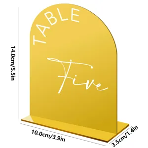 Gold acrylic arched table number sign detail view, elegant wedding decor display stand piece.