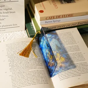 Transparent acrylic dragon bookmark with gold tassel, elegant student stationery detail view.