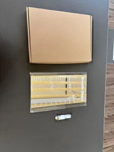 Detailed view of acrylic mirror growth chart wall sticker with packaging and tape.